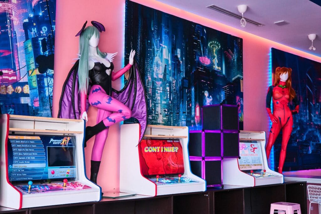 game cabinets with mannequins wearing cosplay.