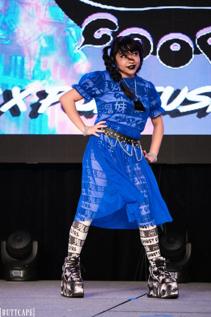 model wearing blue mesh dress posing.