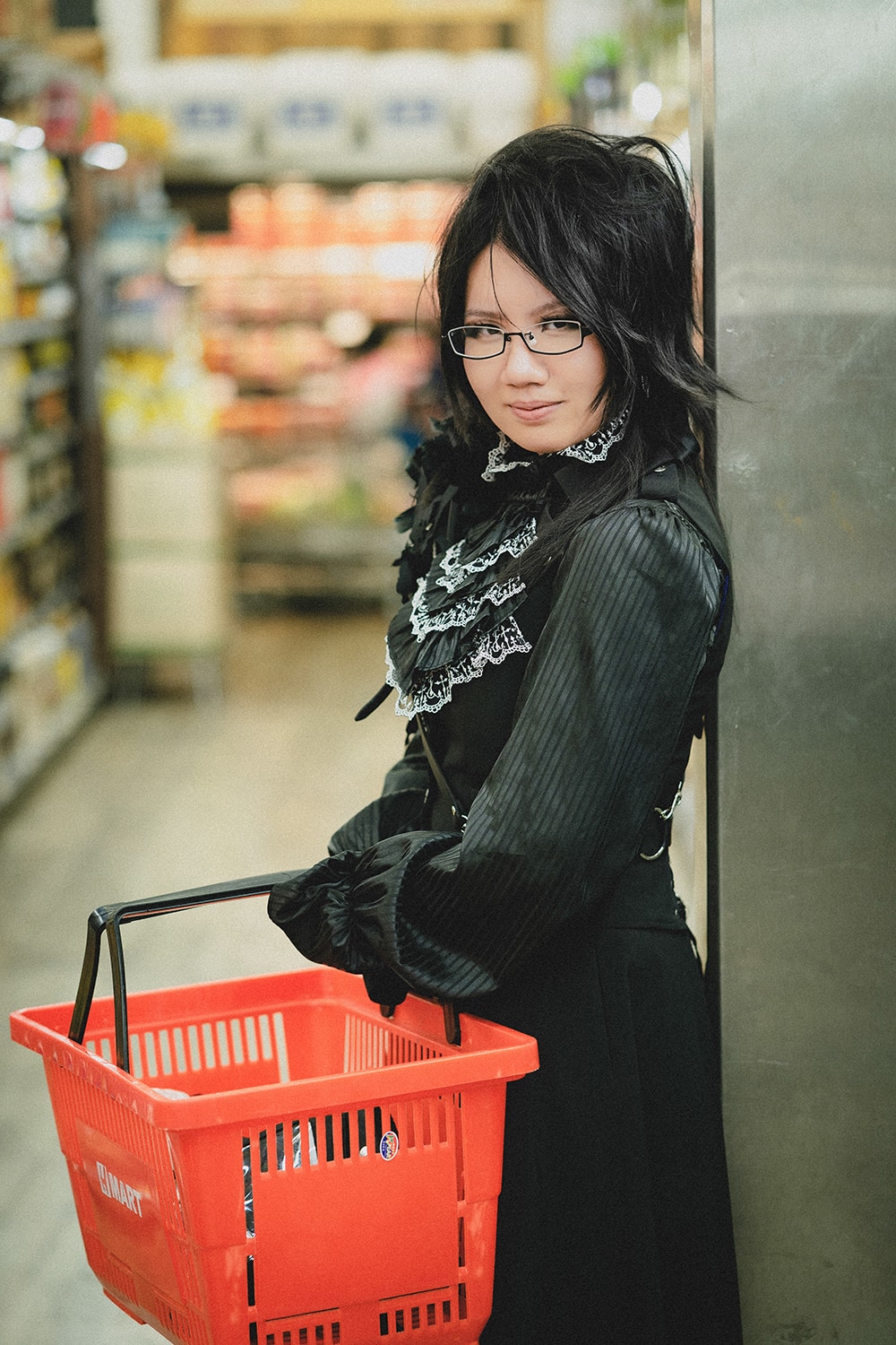 holding a shopping basket in grocery store.