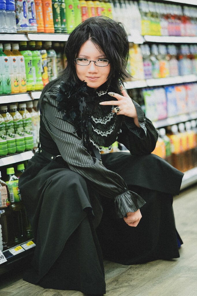 squatting in font of drinks aisle in grocery store, portrait orientation 2.