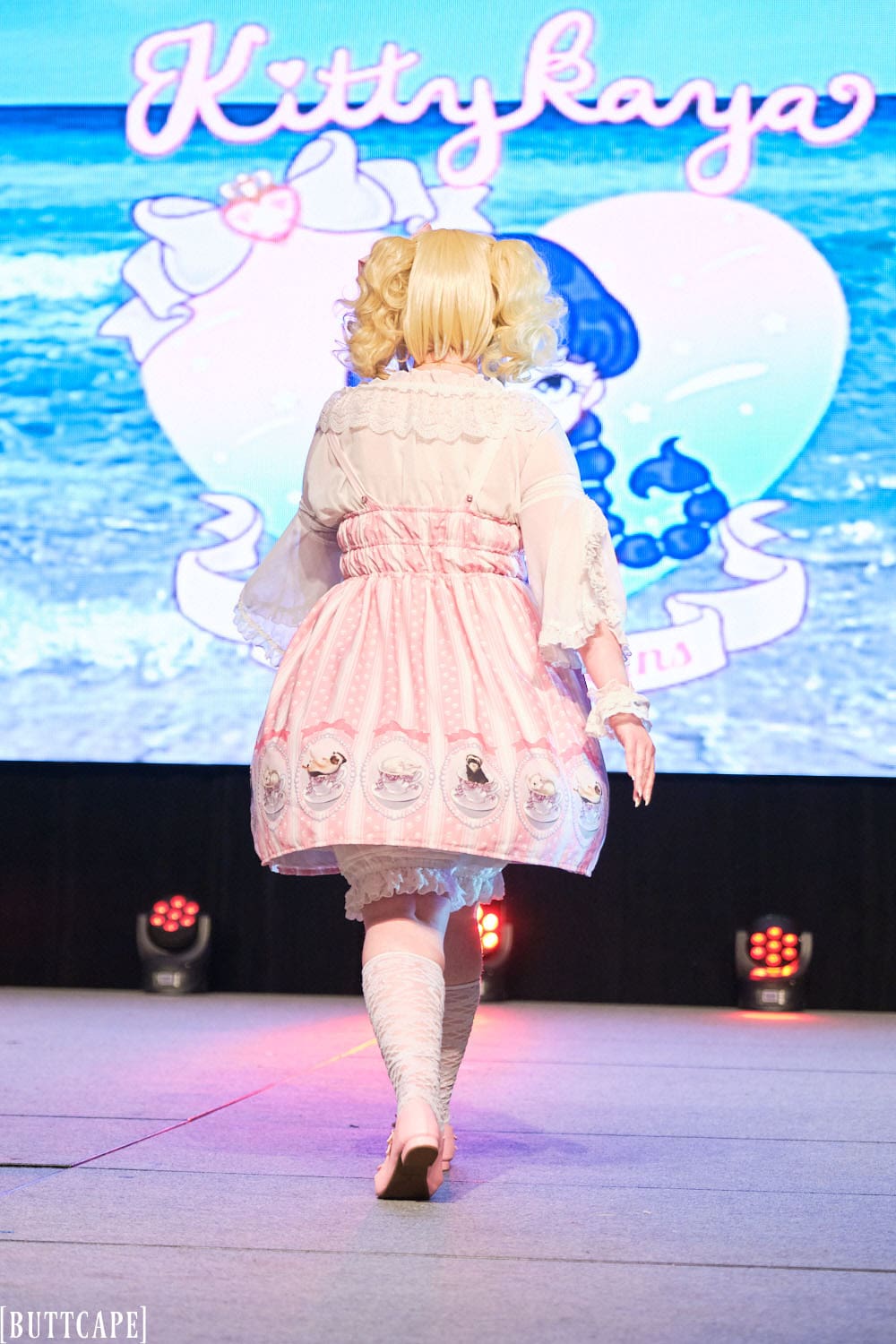 Kittykaya model 4 wearing pink lolita dress with tea cup theme and polka dot fabric - full body backside.