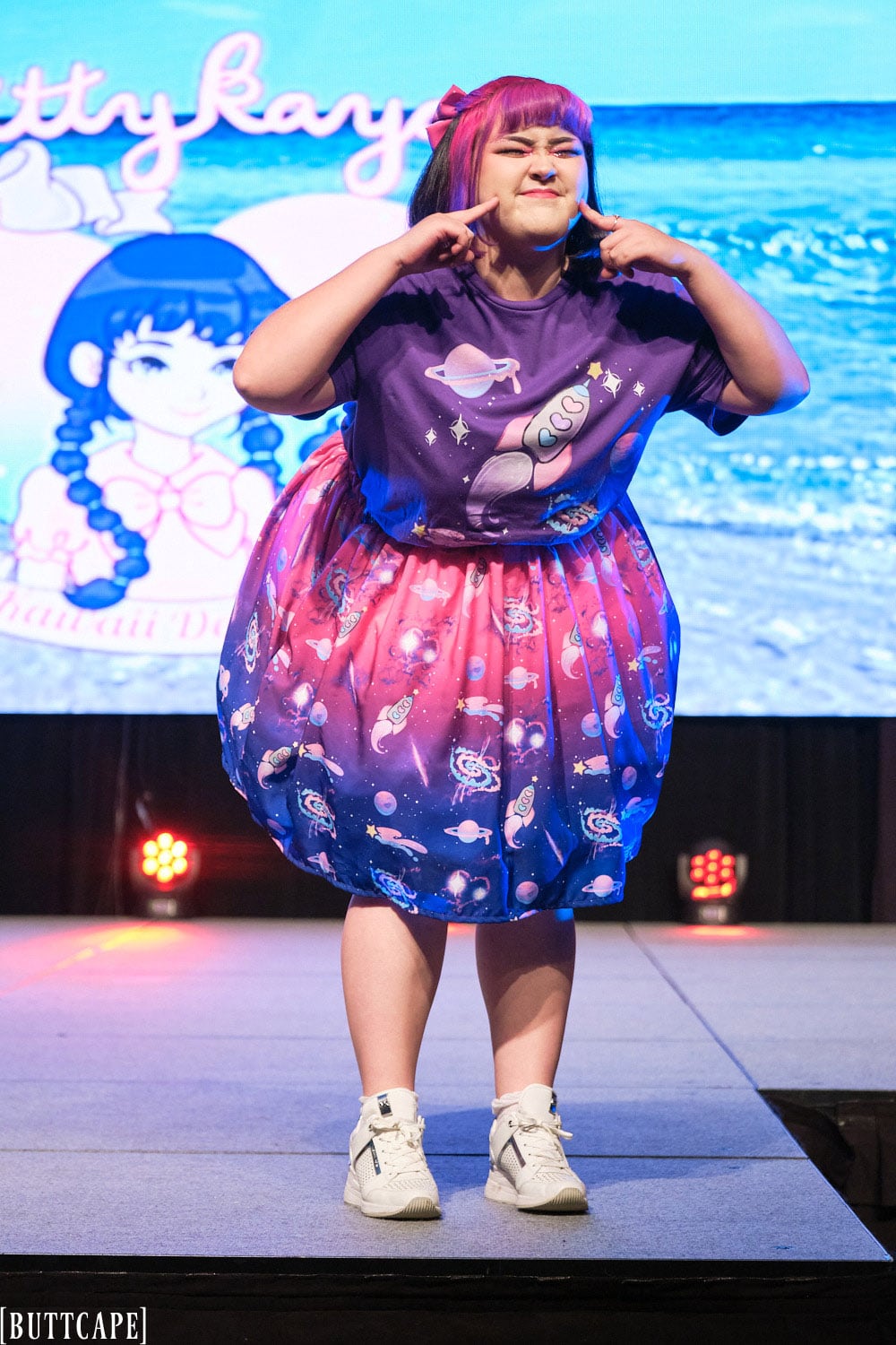 Kittykaya model wearing oversized purple space themed T-shirt, pink and navy gradient space themed skirt - full body 2.