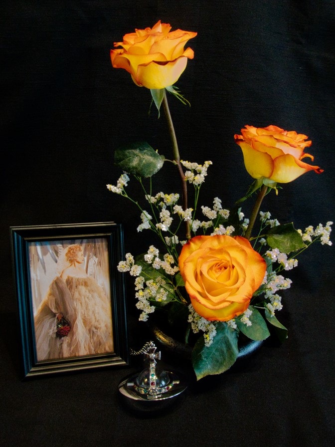 vase of flowers next to framed photo of Vivienne Westwood.