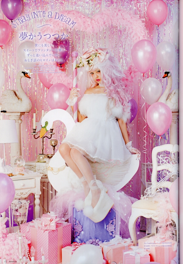 Swan Lake inspired white dress worn with white platform shoes. Model sits on a swan in a room filled with presents, balloons, and pink motifs.