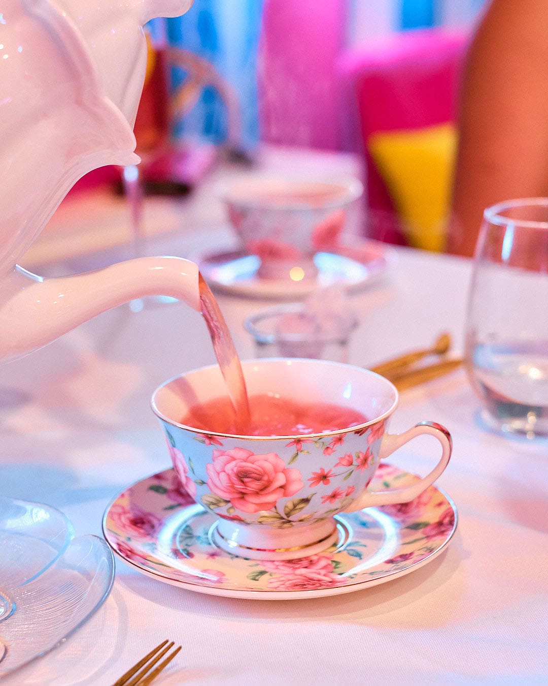 teapot pouring tea into tea cup.