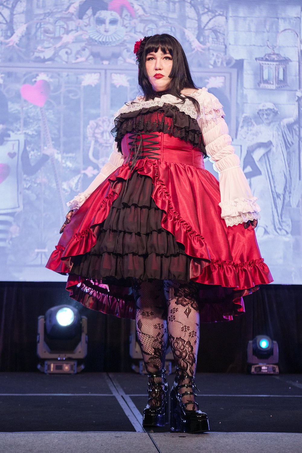 Plus size gothic lolita wearing red and black shantung bustle dress with white princess sleeve blouse, lace tights, and black shoes - full body 1.