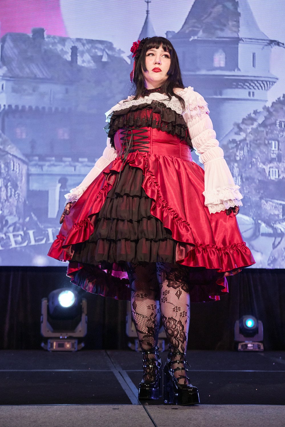 Plus size gothic lolita wearing red and black shantung bustle dress with white princess sleeve blouse, lace tights, and black shoes - full body 2.