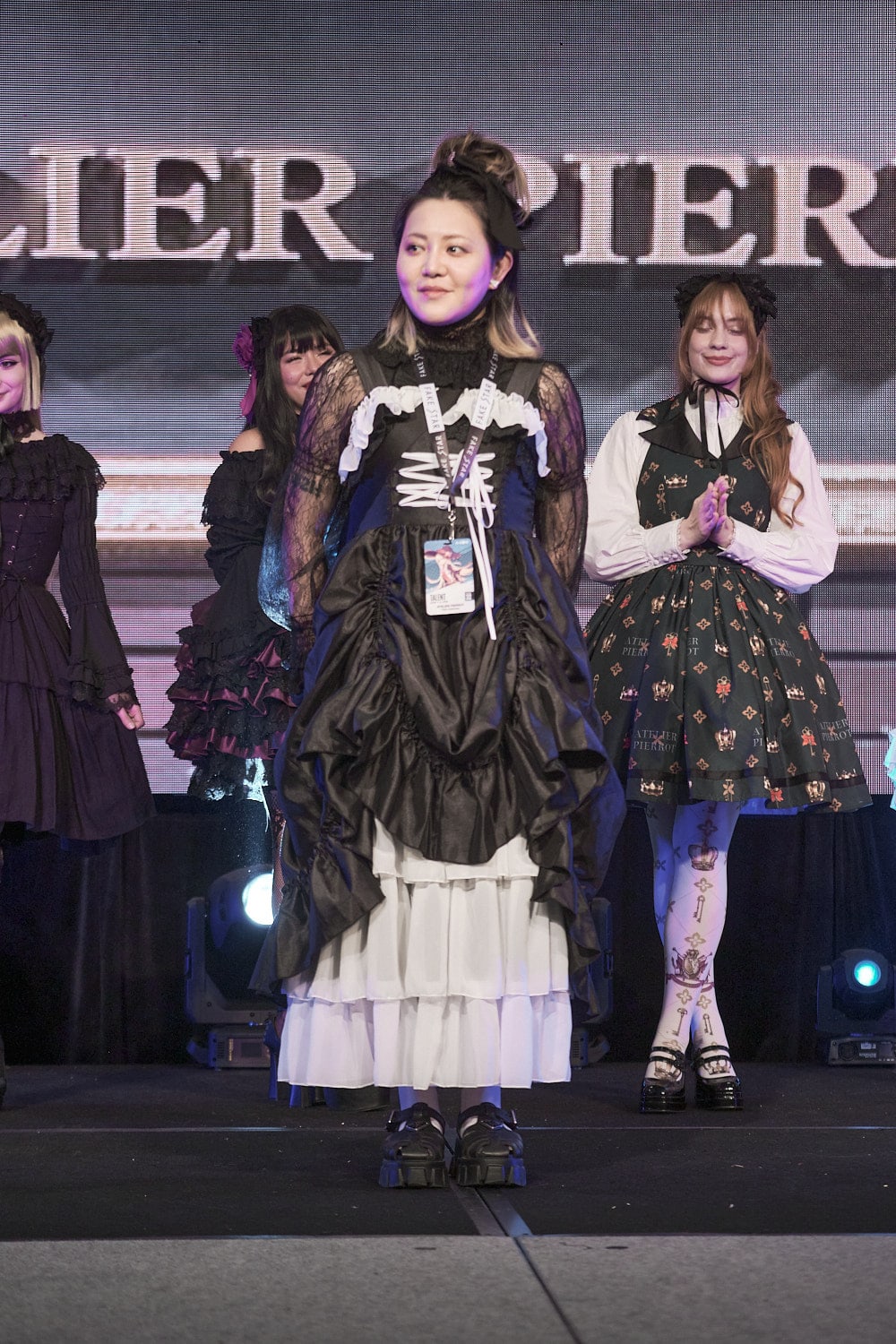 Atelier Pierrot designer standing on stage.