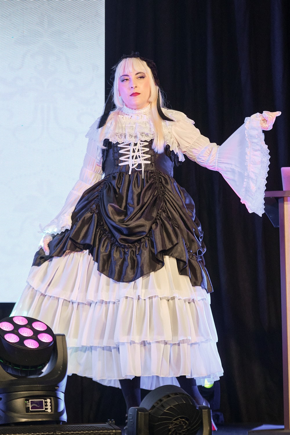 Model wearing black and white bustle and tiered gothic lolita dress - full body 2.