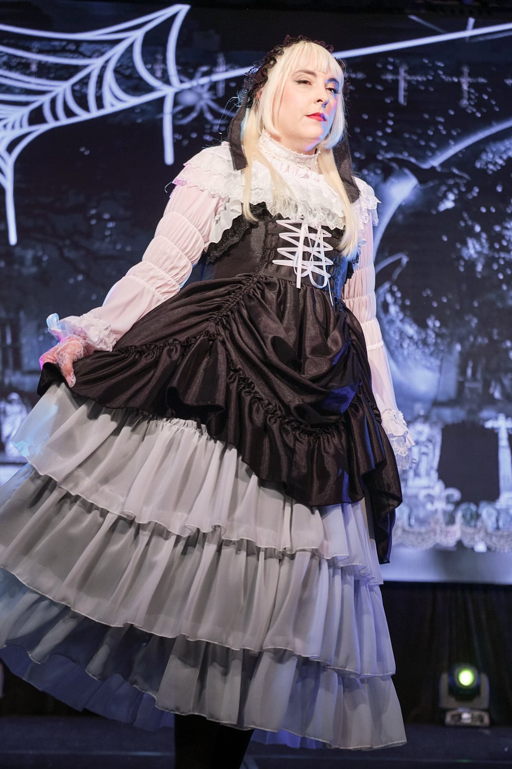 Model wearing black and white bustle and tiered gothic lolita dress - closeup 3.