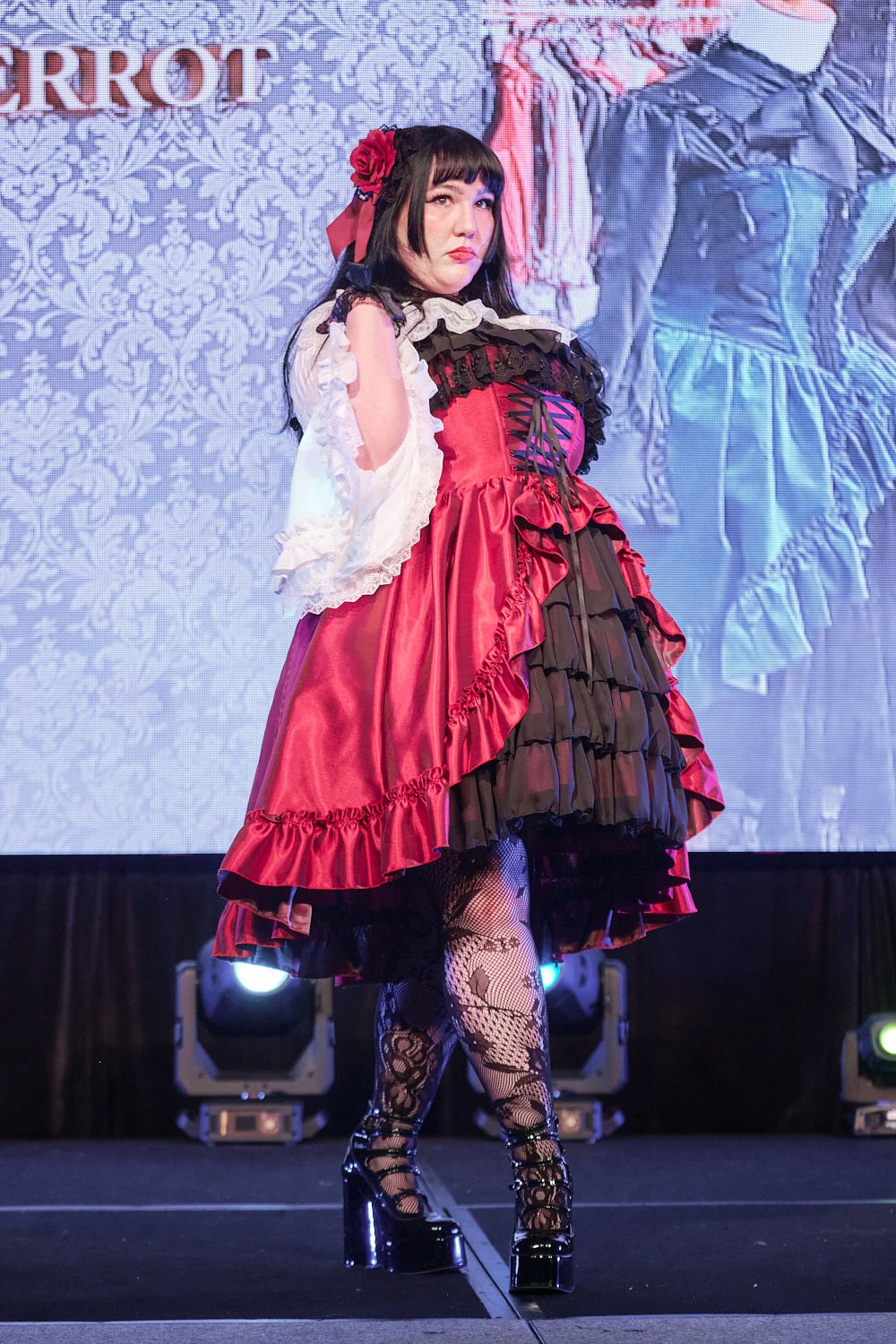 Plus size gothic lolita wearing red and black shantung bustle dress with white princess sleeve blouse, lace tights, and black shoes - full body 4.