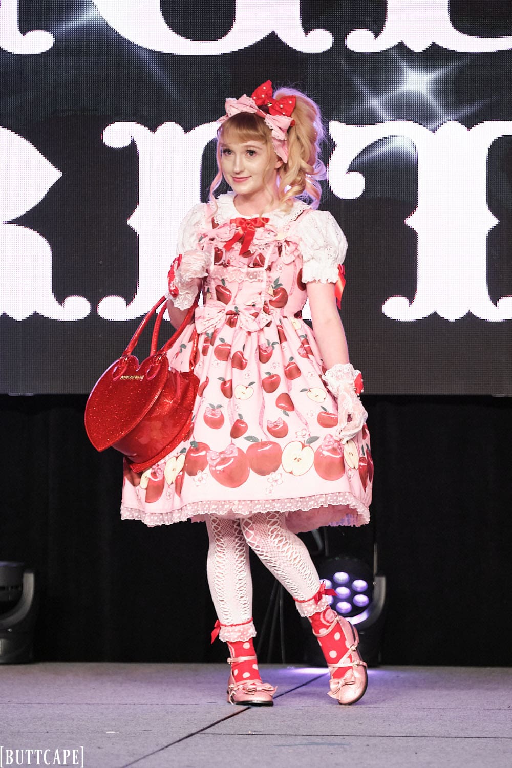 Model 3 wearing pink and red cherry themed lolita outfit - full body 1.