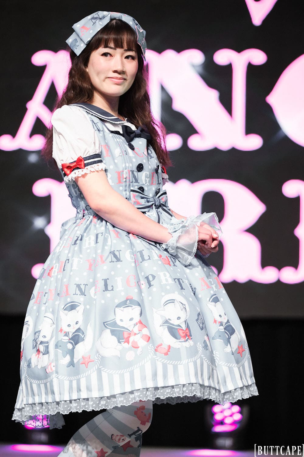 Model 8 wearing grey sailor outfit with cats and stripes - half body 1.