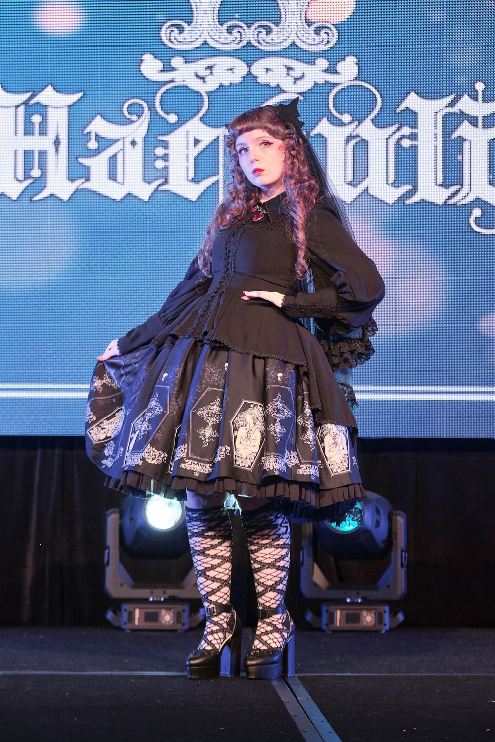 Model 12 wearing gothic lolita bat motif blouse and coffin print skirt - full body 1.