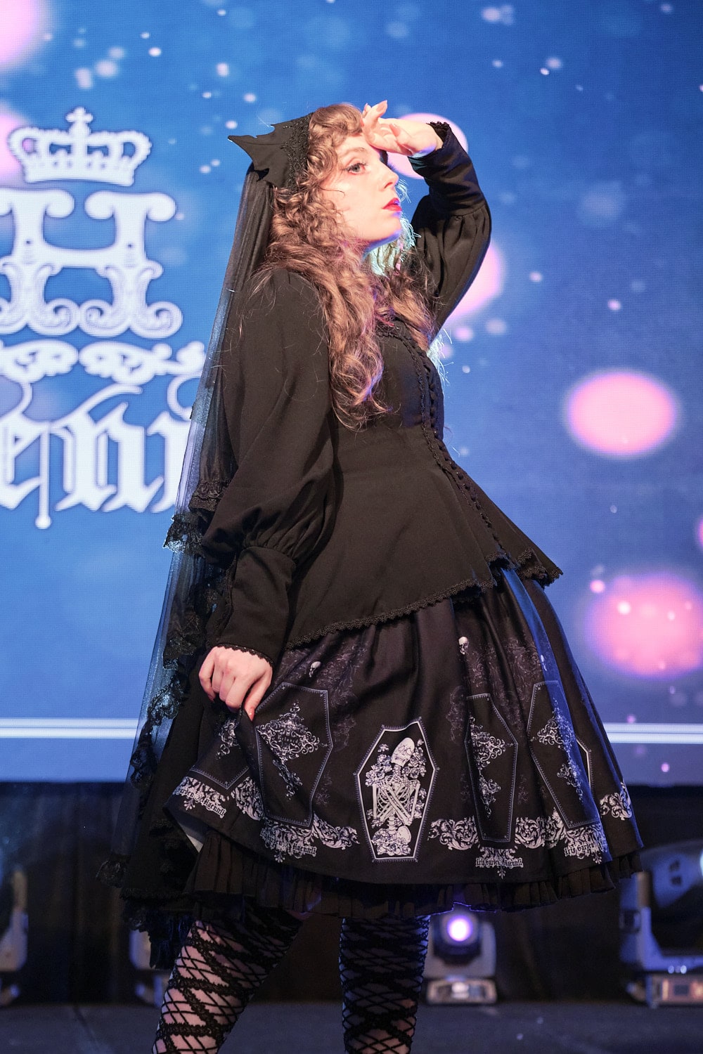 Model 12 wearing gothic lolita bat motif blouse and coffin print skirt - half body 2.