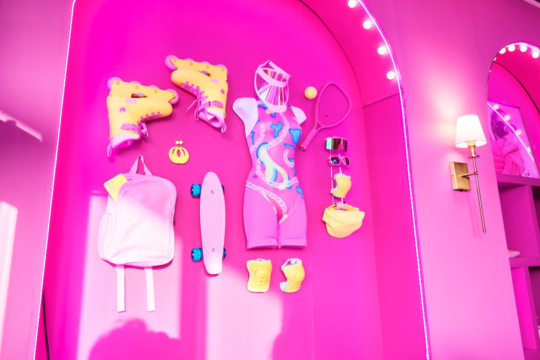 Pink wall with Barbie's roller skating outfit hung.