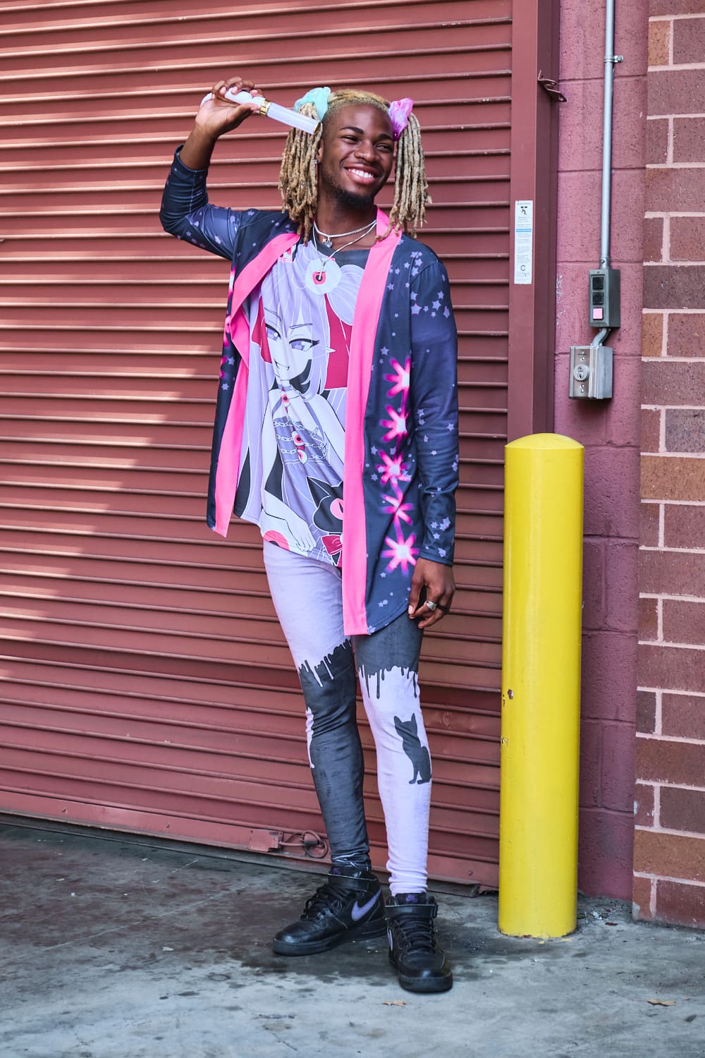 Male model wearing navy and pink cardigan, anime girl T-shirt, and cat print leggings - full body pose 3.