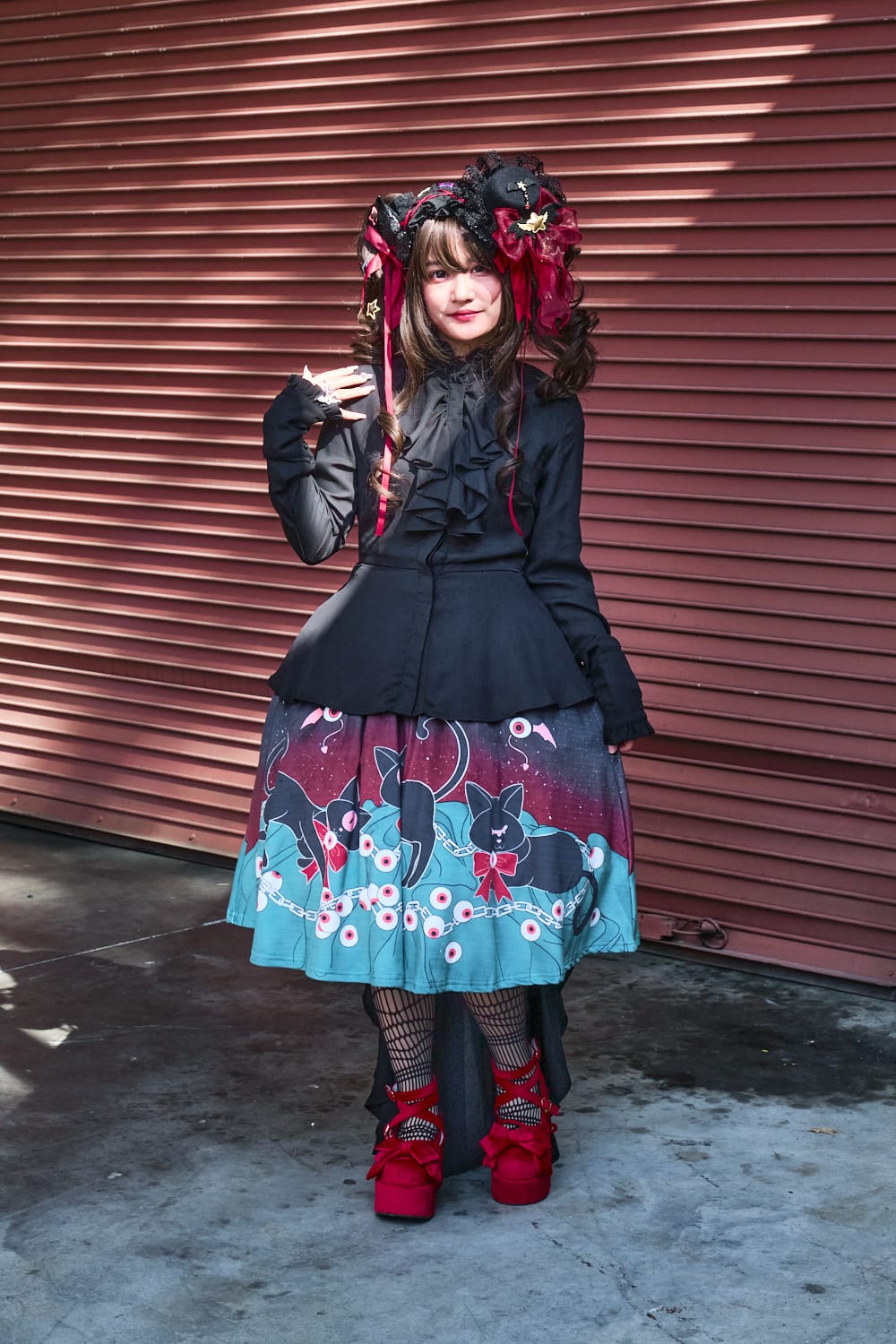 Gothic lolita model wearing black long blouse with cat print skirt - full body pose 4.