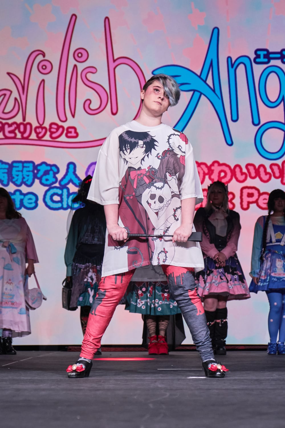 Punk model wearing baggy T-shirt with anime styled couple with bloody print leggings - full body pose 1.