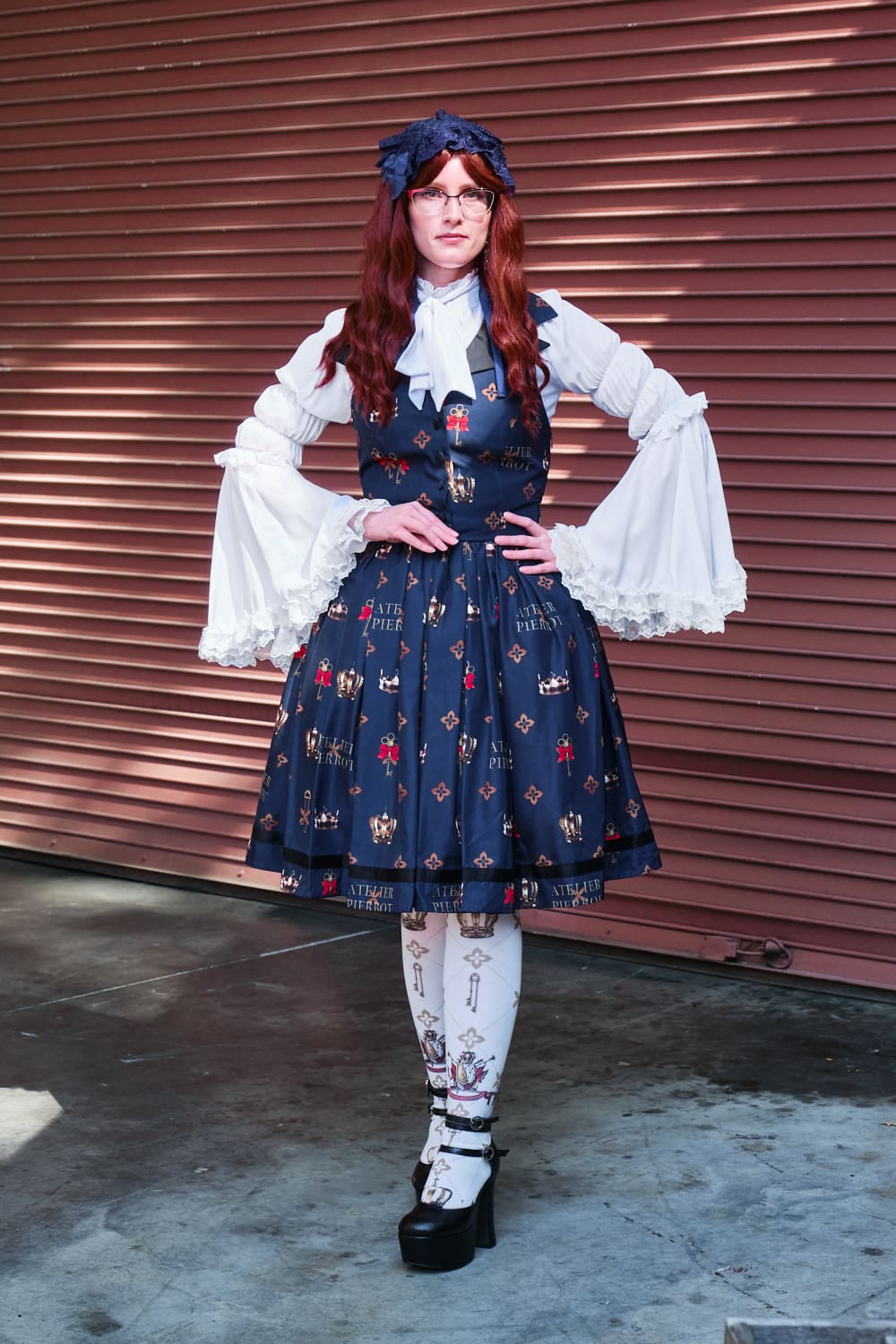 Atelier Pierrot classic lolita model wearing white princess sleeve blouse with crown print vest-style jumperskirt and matching crown tights - full body standing pose 5.