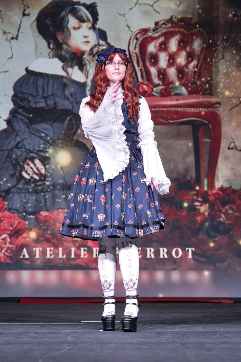 Atelier Pierrot classic lolita model wearing white princess sleeve blouse with crown print vest-style jumperskirt and matching crown tights - full body standing pose 1.