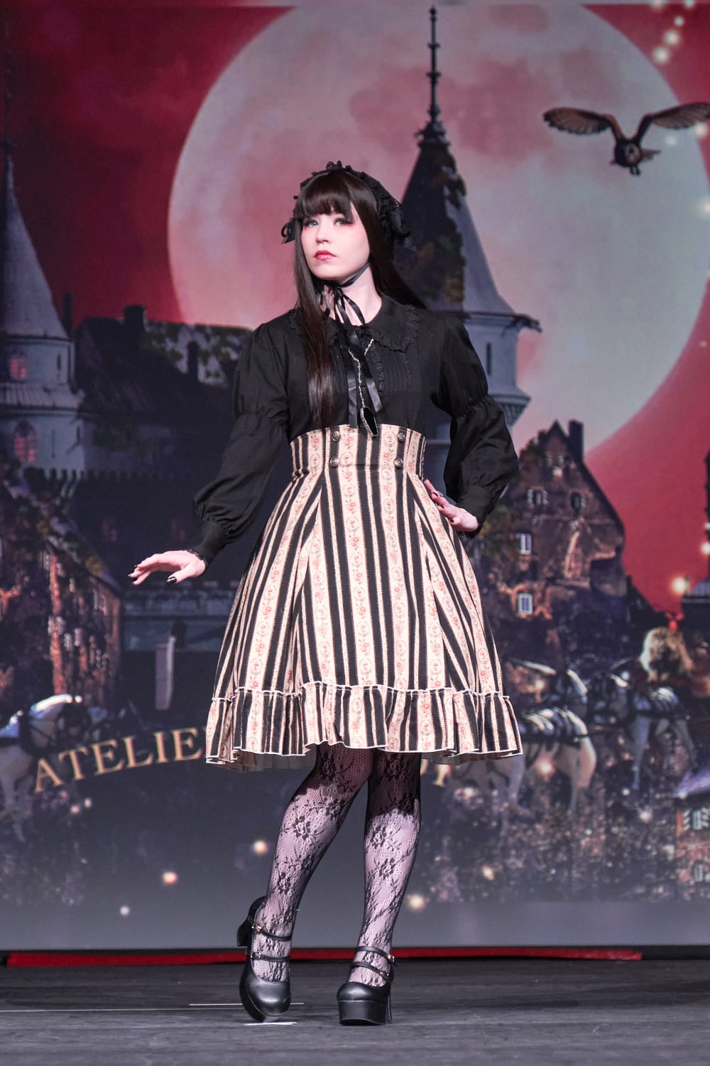 Atelier Pierrot classic lolita model wearing black long sleeve cutsew and floral pattern high waist skirt - full body standing pose 1.