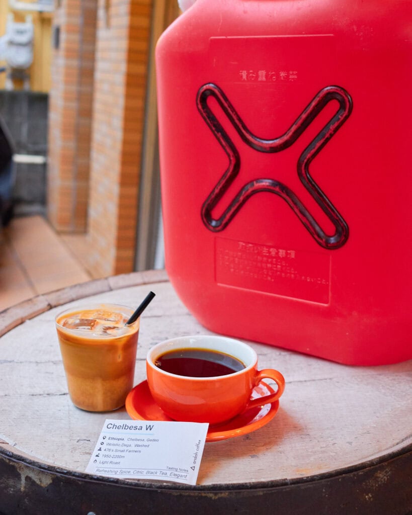 Single origin coffee and iced latte in front of Gasso Coffee logo