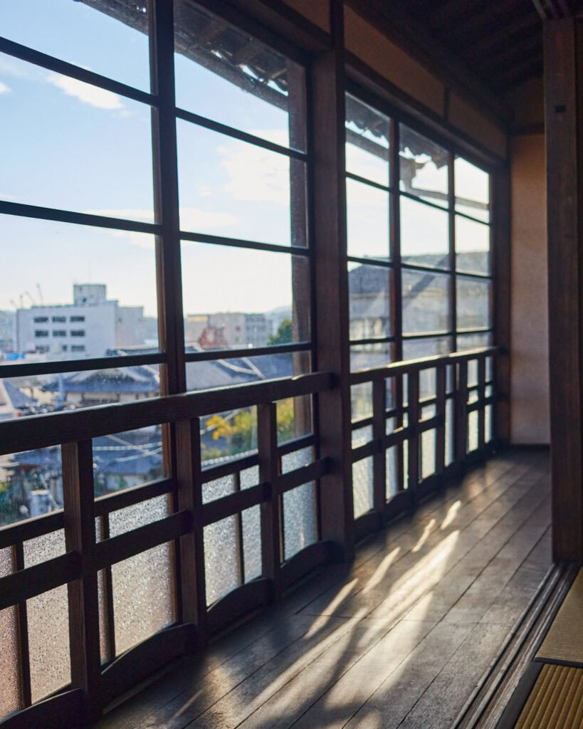 Old Japanese windows and hallway with view of Onomichi in the background