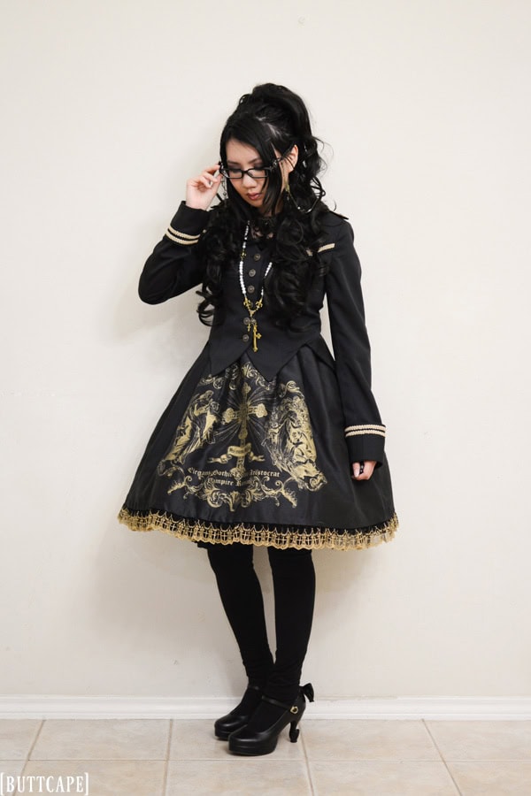Black and gold gothic lolita featuring large religious themed screen print on skirt.