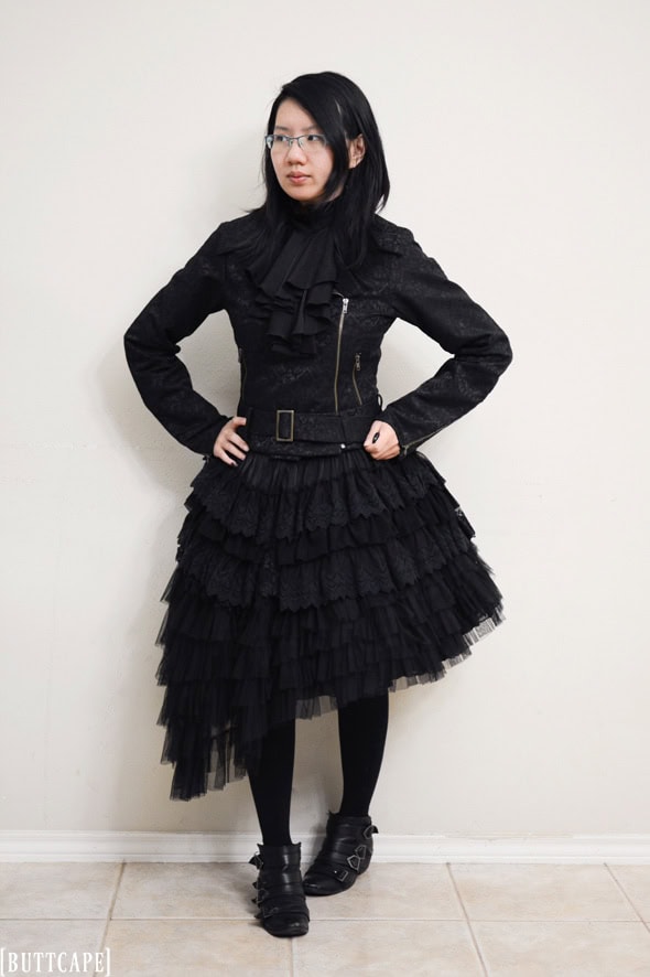 All black gothic punk lolita with riders jacket, asymmetrical skirt, and winklepicker shoes.