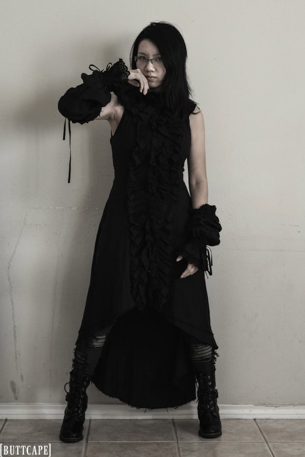 Distressed gauze sleeveless dress and arm warmers paired with ankle boots.