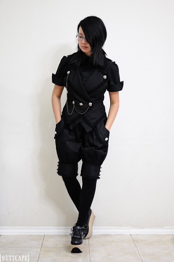 Casual prince outfit with short sleeve blouse, halter vest with chains, pumpkin shorts, black tights, and tassel rockinghorse platform shoes.