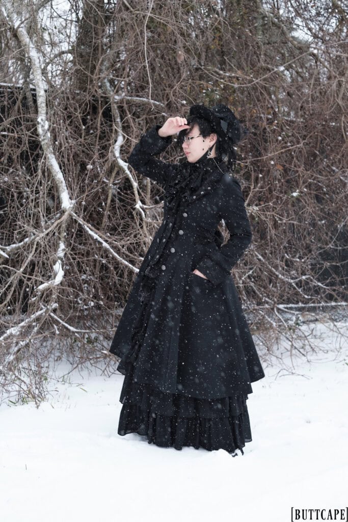 Victorian gothic person wearing all black outfit standing in front of dead tree - 2.