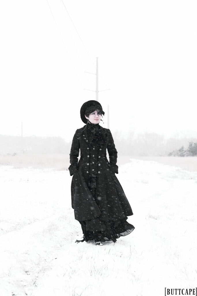 Standing in snow field with hands in pockets.