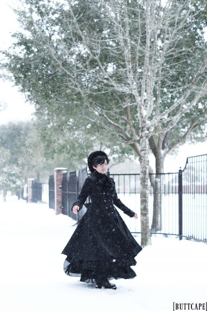 Victorian gothic person spinning in snow.