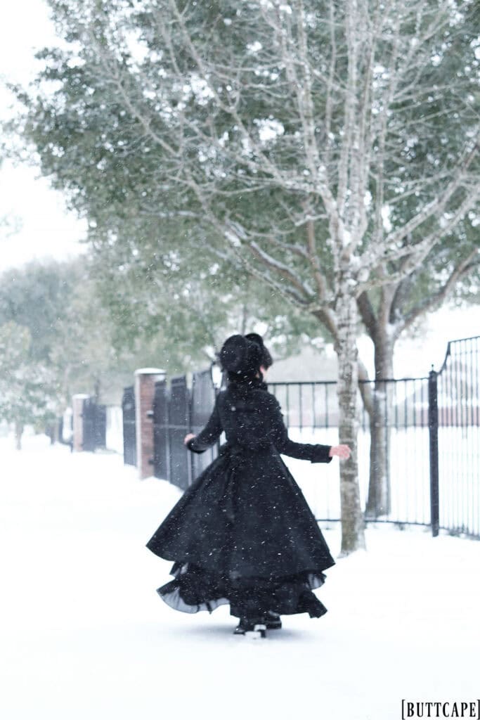 Victorian gothic person spinning in snow - backside.