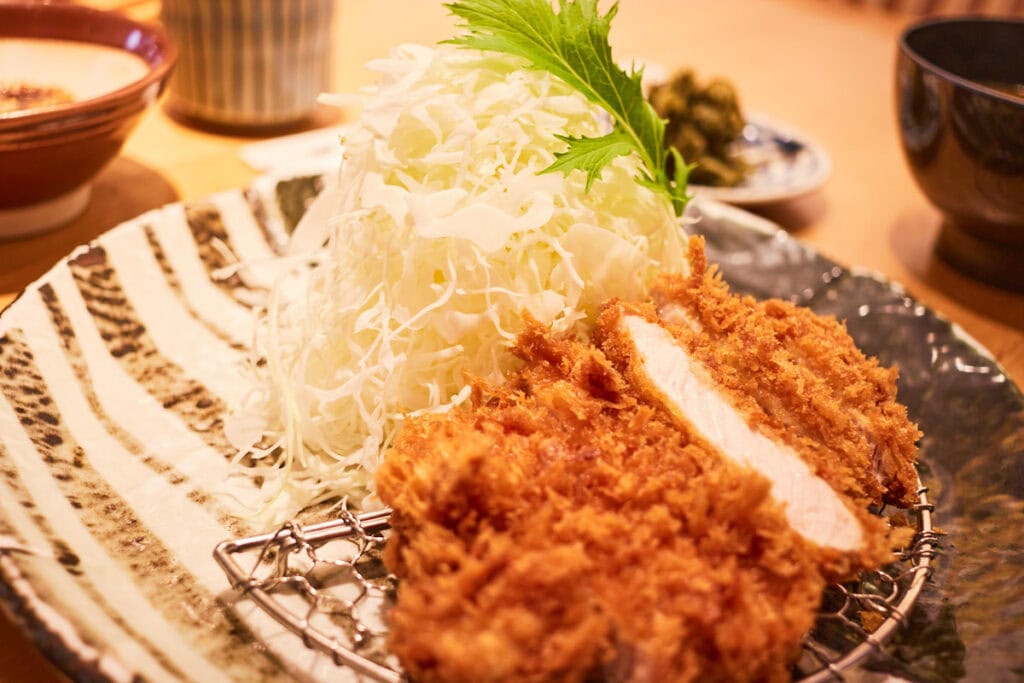 Close up of Katsukura Kyoto Tonkatsu deep fried pork cutlet with cabbage salad