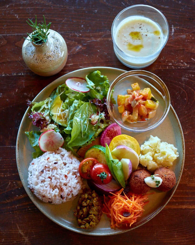 Veg Out Plate featuring seasonal local vegetables, rice, and corn soup