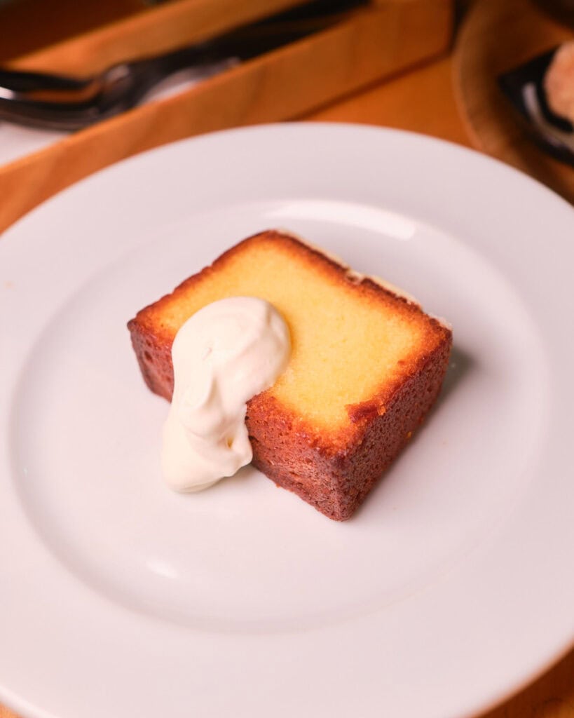 chano-ma hiroshima seto uchi lemon pound cake on a white plate topped with whipped cream