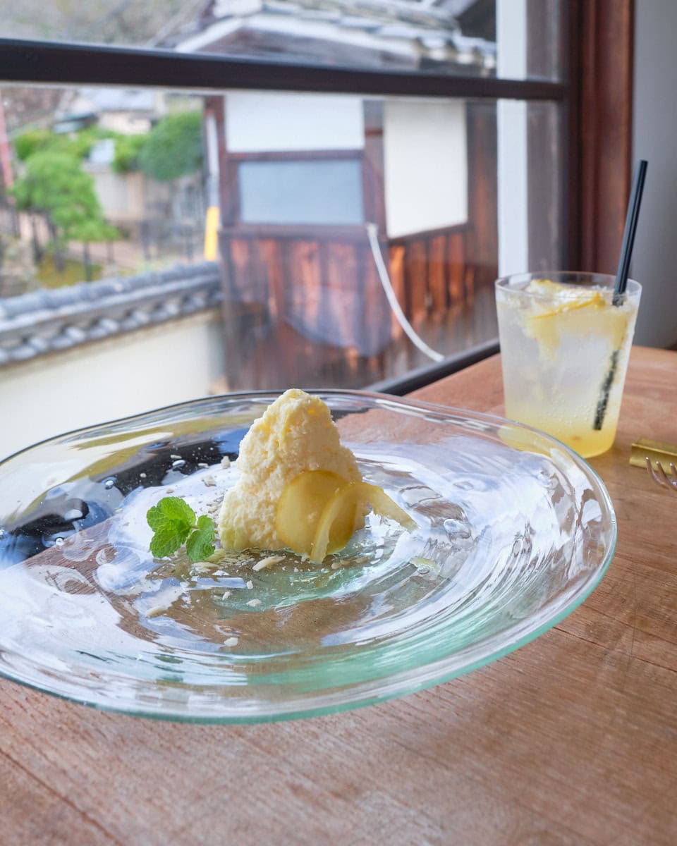 Hiroshima setouchi lemon cheesecake on a glass plate and setouchi lemon soda from kakiwai cafe