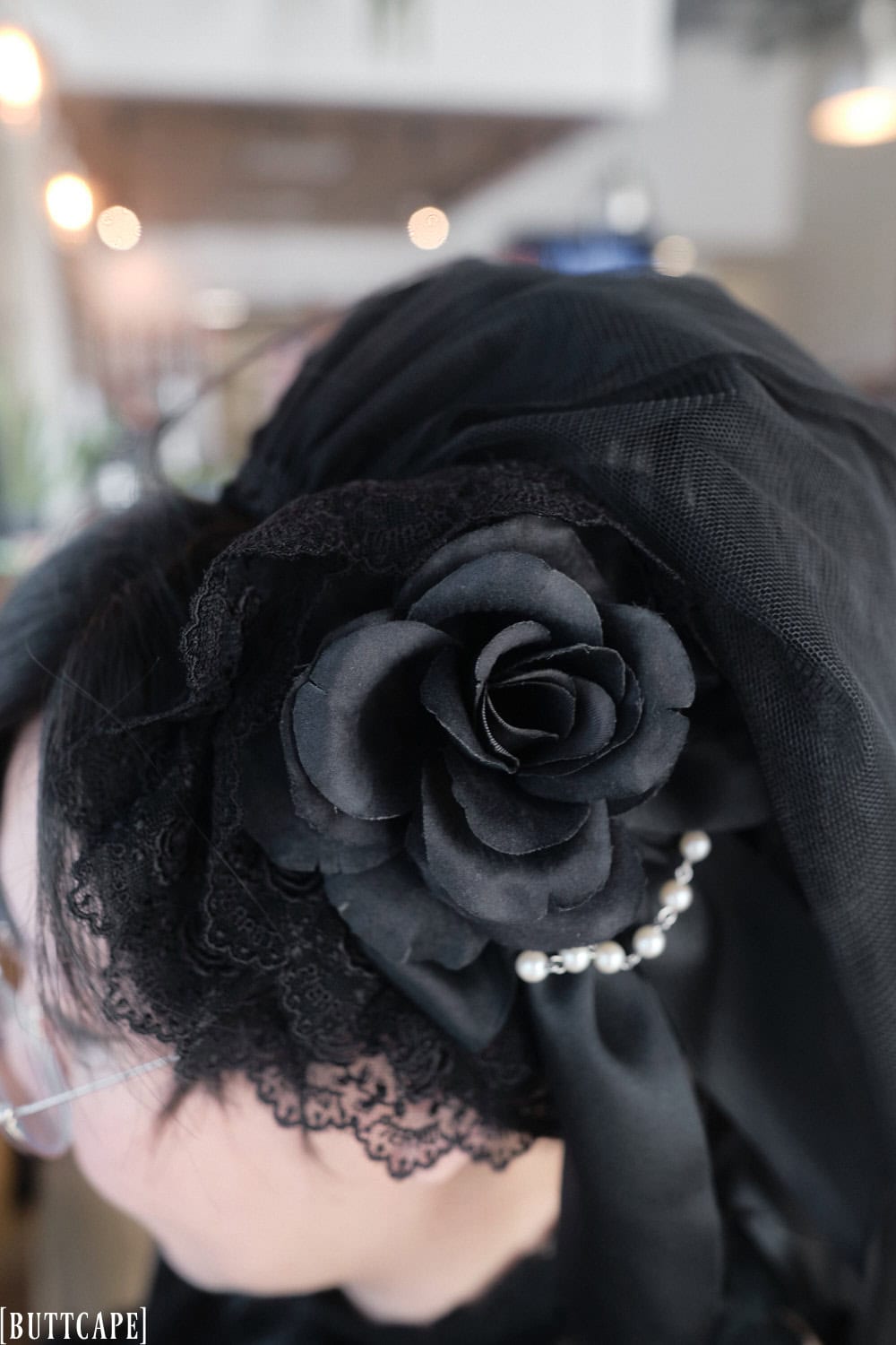 Lace headdress with rose and veil.