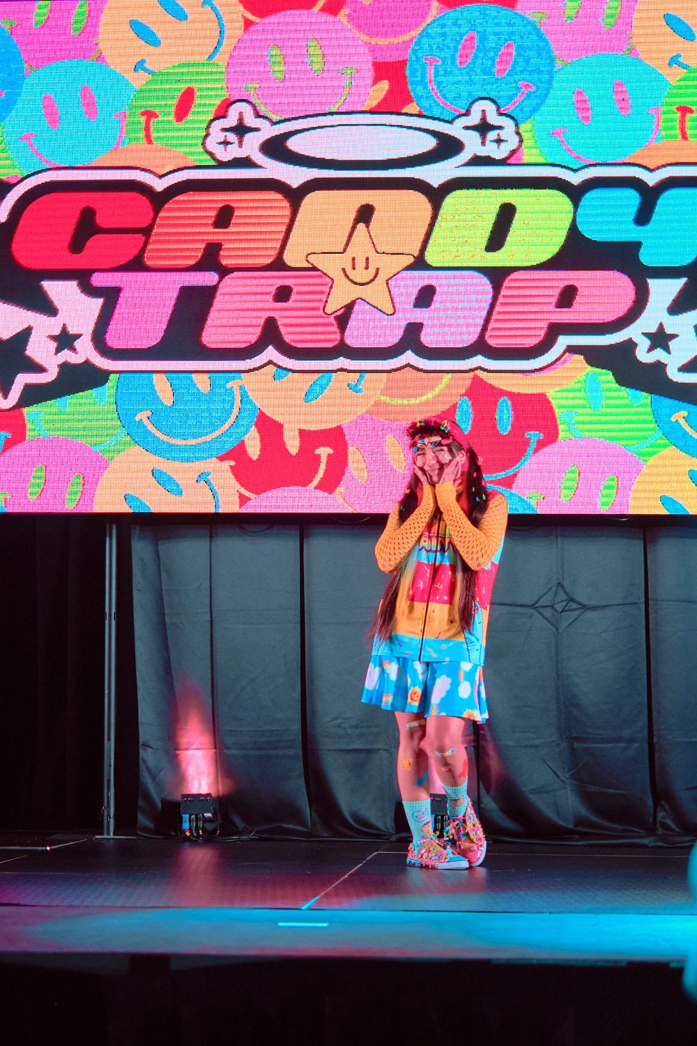 Candy Trap model #5 wears casual decora style with parka, pleated skirt, and fun socks.