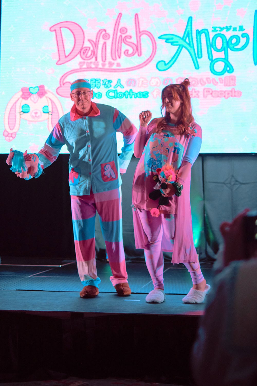 Devilish Angel models #4 and #5 wearing matching pink and sax pajama sets. Model on left wears striped ensemble of button up and stripe pants. Model on right wears long t-shirt and peignor.