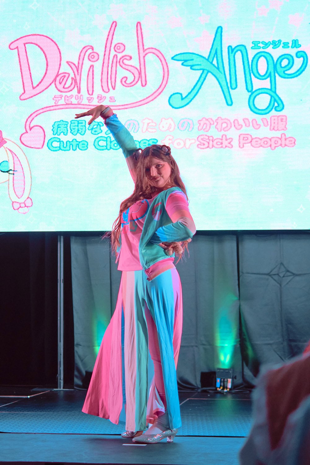 Devilish Angel model #6 wearing long maxi rainbow skirt and hooded parka,