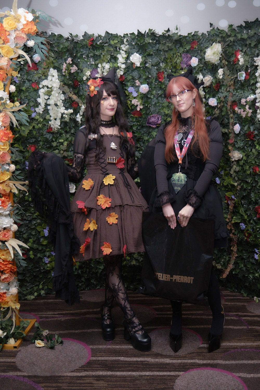 Two gothic lolitas standing next to each other.
