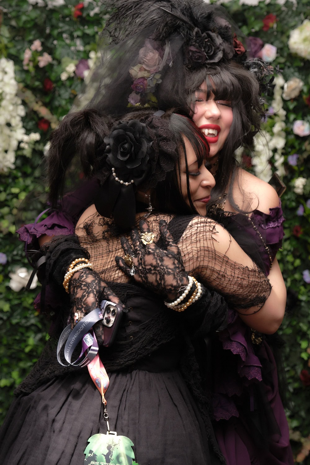 Two gothic lolitas hugging.