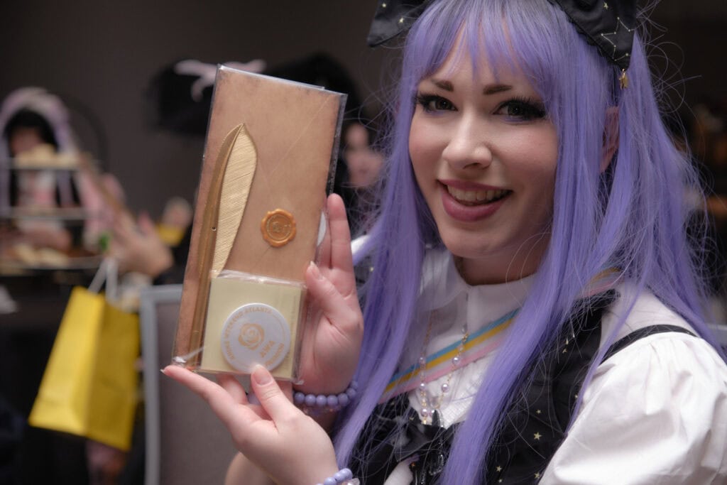 Woman holding stationary set up.
