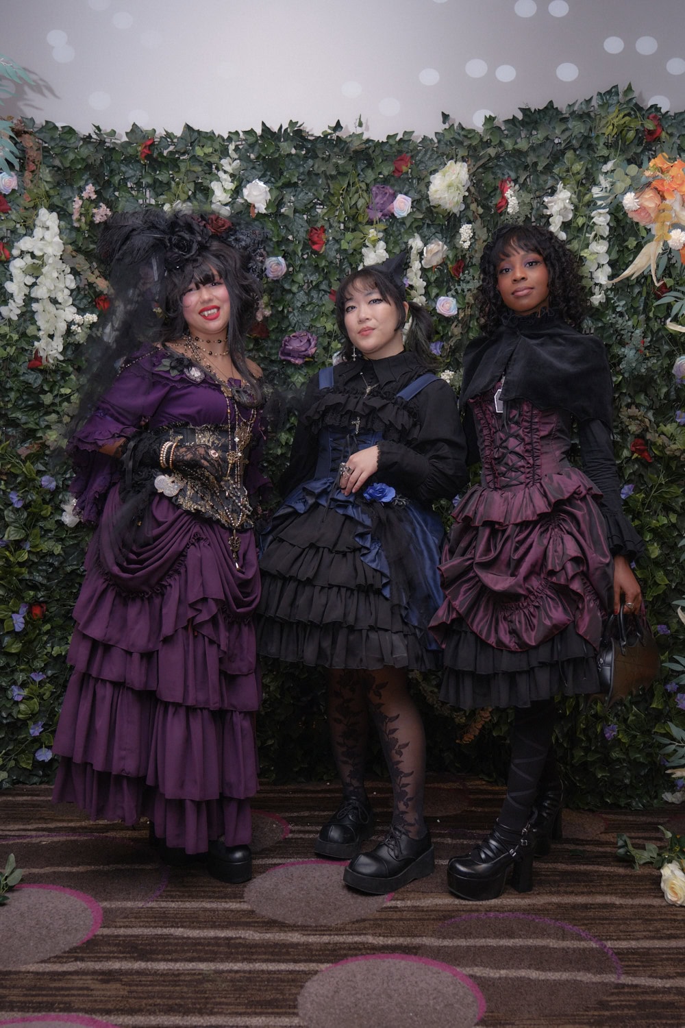 Three gothic lolitas wearing Atelier Pierrot standing together.