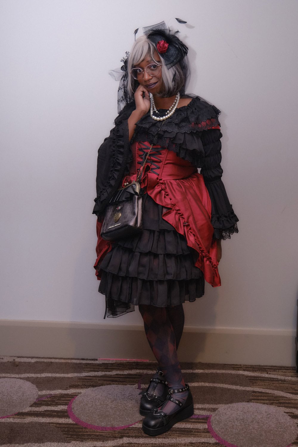 Gothic lolita wearing red and black.