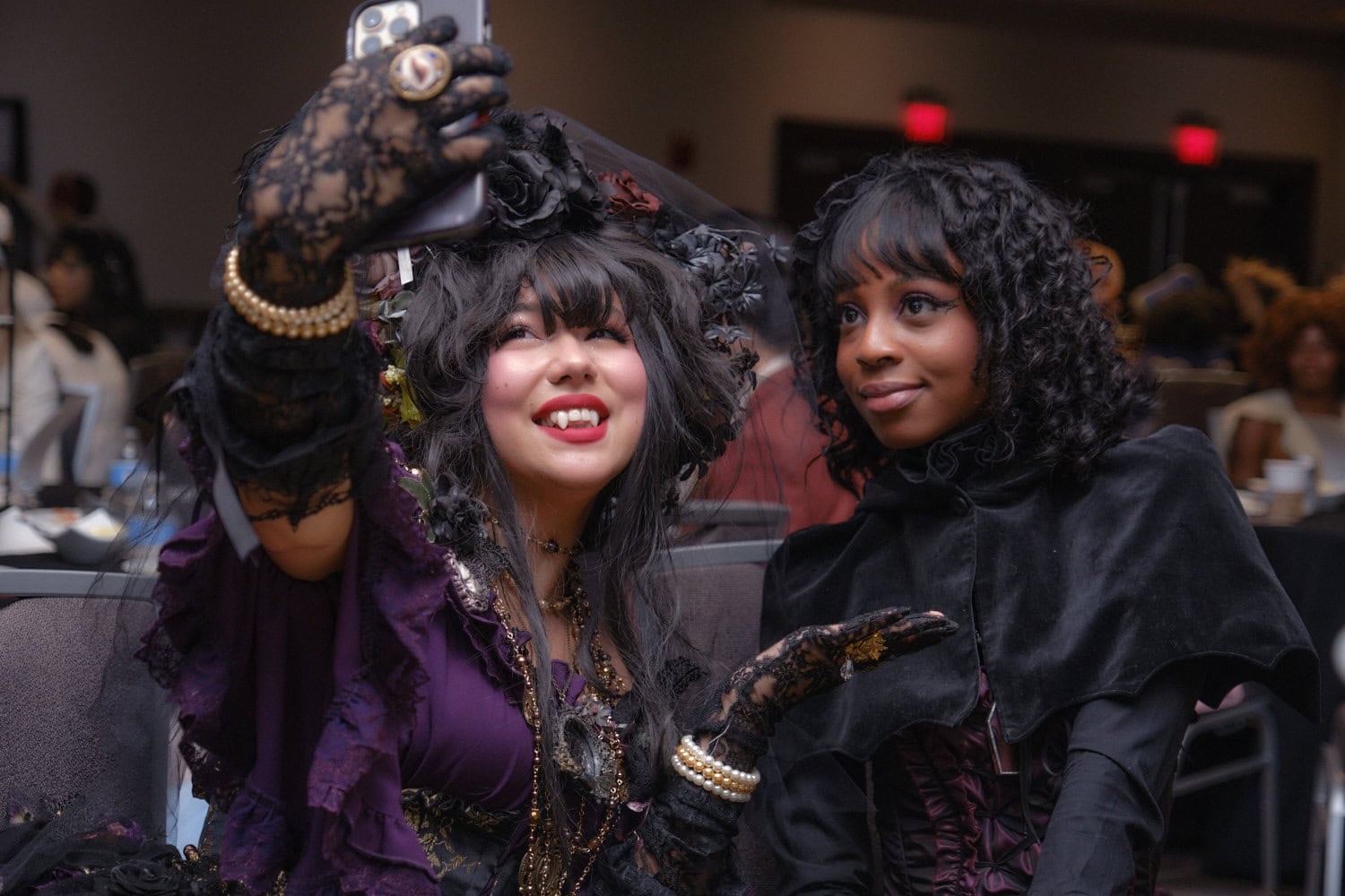 Two gothic lolitas taking selfie.